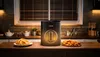 An air fryer is shown on a kitchen counter with plates of fries and chicken nuggets in front of it. Náhľad obrázku produktu