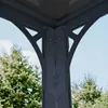 Close-up of the corner joint of a gray metal gazebo structure against a blue sky and trees. Podgląd zdjęcia produktu