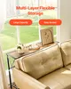 A narrow console table with a wooden top and black metal legs is placed next to a tan leather sofa in front of a large window with a view of greenery. Anteprima dell’immagine prodotto