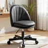 A black office chair is shown in a room with a desk and a plant. Náhled obrázku produktu
