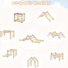 A collage of different configurations of a wooden climbing structure for children, set against a light pink and white background with cloud-like shapes. Podgląd zdjęcia produktu