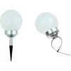Two solar garden lights are shown against a white background. One is upright with a spike for ground insertion, and the other is tilted with a cable tie attached. Náhled obrázku produktu