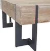 A close-up view of the corner of a rustic wooden coffee table with dark metal legs. Voir les images du produit
