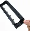 A hand is holding a black plastic part, likely a component of a vacuum cleaner, against a white background. Produktbild-Vorschau