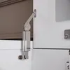 Close-up of a cabinet hinge and gas strut mechanism. Podgląd zdjęcia produktu