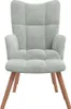 A light gray velvet armchair with wooden legs, shown from the front against a white background. Náhľad obrázku produktu