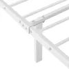 A close-up view of a white metal bed frame, showing the connection points and support slats. Produktbild-Vorschau