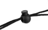 A close-up of a black plastic cord lock with two black cords passing through it. Náhľad obrázku produktu