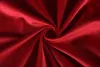 A close-up of red velvet fabric, swirled into a vortex. Produktbild-Vorschau