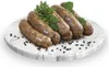 Sausages are arranged on a marble platter with peppercorns and garnished with parsley and mint. Produktbild-Vorschau