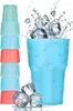 A stack of colorful plastic cups on the left and a single large blue cup with ice and water splashing out on the right. There are also three ice cubes in the foreground. Produktbild-Vorschau