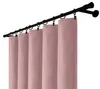 A close-up view of pink velvet curtains hanging from a black curtain rod. Podgląd zdjęcia produktu