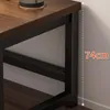 Close-up of the corner of a desk, showing the wooden top and black metal legs. A dashed line indicates a measurement. Náhled obrázku produktu
