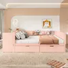 A pink children's bed with drawers and a shelf, decorated with pillows and a painting. Anteprima dell’immagine prodotto