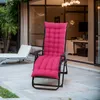 A pink cushion on a black recliner chair on a patio, with another white lounge chair in the background. Náhled obrázku produktu
