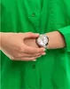 A person's arm wearing a Tommy Hilfiger watch against a green shirt. Produktbild-Vorschau