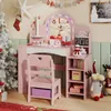 A child's pink vanity set with a chair, decorated for Christmas with a tree and stockings. Náhled obrázku produktu