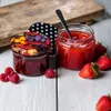 Two jars of jam with fruit and berries on a white wooden surface. Podgląd zdjęcia produktu