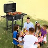 A family is having a picnic and grilling outdoors. Produktbild-Vorschau