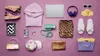 A flat lay arrangement of various fashion and travel items on a pinkish-purple background. Produktbild-Vorschau