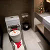 A bathroom decorated for Christmas with a snowman-themed toilet seat cover and a small Christmas tree on the counter. Anteprima dell’immagine prodotto