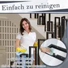 A woman is cleaning a black metal stair railing indoors. Náhled obrázku produktu