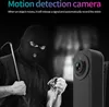 A masked figure holding a crowbar and jewelry, with a motion detection camera in the foreground. Náhled obrázku produktu