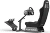 A black racing simulator seat with a steering wheel and pedals, shown from a three-quarter angle against a white background. Produktbild-Vorschau
