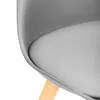 A close-up view of a chair's seat and leg. Náhľad obrázku produktu