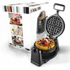 A waffle maker is shown open with a waffle inside, next to its packaging which displays product images. Podgląd zdjęcia produktu