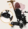 A pink and black multifunctional tricycle with a canopy and parent handle. Produktbild-Vorschau