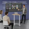 People in an office or classroom setting interacting with a large screen and a standing desk. Voir les images du produit