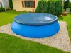An inflatable pool covered with a dark gray cover, situated on a gravel base in a grassy backyard. Produktbild-Vorschau
