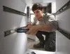A man is installing drawer slides in a cabinet using a Bosch cordless screwdriver. Voir les images du produit