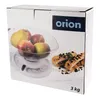 The image shows the packaging for a mechanical kitchen scale with a bowl, filled with apples and a pear. A graphic of two pastries is also visible on the packaging. Voir les images du produit