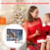 A mother and daughter are looking at an advent calendar with Christmas decorations in the background. Produktbild-Vorschau
