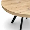 A close-up view of a round wooden table with black metal legs. Produktbild-Vorschau