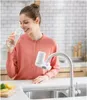 A woman is drinking water from a glass next to a kitchen sink with a faucet water filter attached. Náhľad obrázku produktu