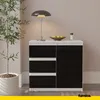 A modern sideboard with drawers and a door, placed in a room with a plant and a lamp. Náhled obrázku produktu