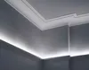 A corner of a room showing crown molding with integrated LED lighting. Produktbild-Vorschau