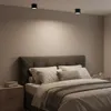 A bedroom scene with a bed, nightstand, and ceiling lights. Náhľad obrázku produktu