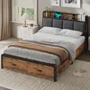 A bedroom scene featuring a bed with a headboard charging station and storage drawers. Produktbild-Vorschau