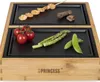 A close-up shot of a Princess Chef-Tischgrill Dinner4All Pure with food items on its grill plates. Produktbild-Vorschau