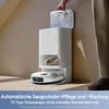 A person is shown filling a water tank on a white robotic vacuum cleaner station. Produktbild-Vorschau