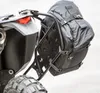 Close-up view of a black adventure pack attached to a motorcycle's luggage rack. Produktbild-Vorschau