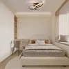 A modern bedroom with a bed, desk, and chair, featuring a geometric ceiling light. Produktbild-Vorschau