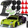 A collection of items for an RC car set, including the car, remote control, batteries, spare tires, and traffic cones. Voir les images du produit