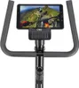 A tablet mounted on the handlebars of a stationary exercise bike. Náhľad obrázku produktu