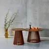 Two wooden side tables with a vase of greenery and fruit on one table. Produktbild-Vorschau