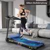 A woman is running on a treadmill in a modern living room. Voir les images du produit